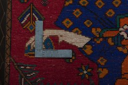 Backside of handmade 2000s Shiraz rug showing knot structure and weave density