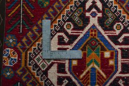 Backside of handmade 2000s Shiraz rug showing knot structure and weave density