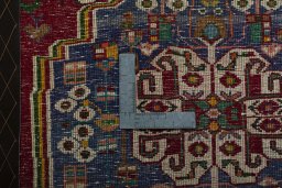 Backside of handmade 2000s Shiraz rug showing knot structure and weave density