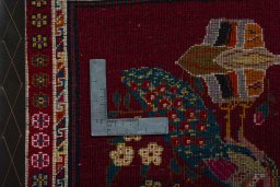 Backside of handmade 2000s Shiraz rug showing knot structure and weave density