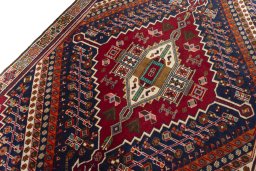 Backside of handmade 2000s Shiraz rug showing knot structure and weave density