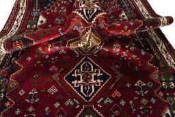 Corner detail of 2000s Shiraz rug showing border pattern and Wool pile