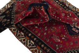 Corner detail of 2000s Shiraz rug showing border pattern and Wool pile