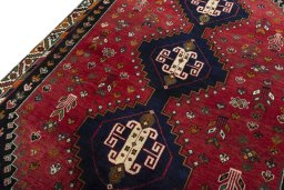 Backside of handmade 2000s Shiraz rug showing knot structure and weave density