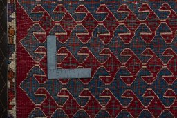 Backside of handmade 2000s Shiraz rug showing knot structure and weave density