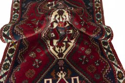 Corner detail of 2000s Shiraz rug showing border pattern and Wool pile