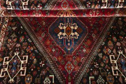 Full view of 2000s Shiraz rug from Iran / Persia, 277 × 181 cm in Red tones