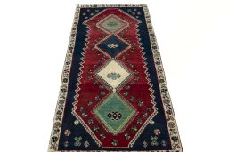 Surface texture of 2000s Shiraz rug with natural Wool and intricate pattern