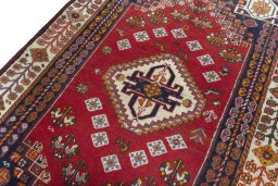 Backside of handmade 2000s Shiraz rug showing knot structure and weave density