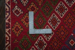 Backside of handmade 2000s Shiraz rug showing knot structure and weave density