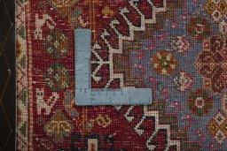 Backside of handmade 2000s Shiraz rug showing knot structure and weave density