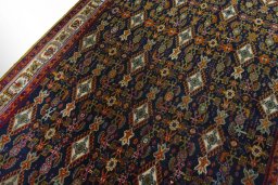 Backside of handmade 2000s Shiraz rug showing knot structure and weave density