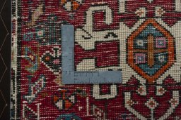 Backside of handmade 2000s Shiraz rug showing knot structure and weave density