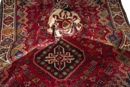 Corner detail of 2000s Shiraz rug showing border pattern and Wool pile