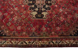Corner detail of 2000s Shiraz rug showing border pattern and Wool pile