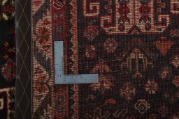 Backside of handmade 2000s Shiraz rug showing knot structure and weave density