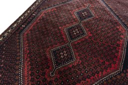 Backside of handmade 2000s Shiraz rug showing knot structure and weave density