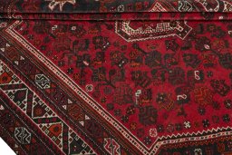 Corner detail of 2000s Shiraz rug showing border pattern and Wool pile
