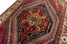 Backside of handmade 2000s Shiraz rug showing knot structure and weave density