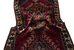 Corner detail of 2000s Shiraz rug showing border pattern and Wool pile
