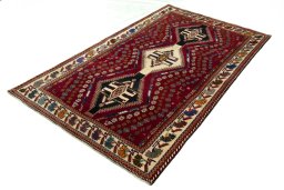 Corner detail of 2000s Shiraz rug showing border pattern and Wool pile