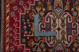 Backside of handmade 2000s Shiraz rug showing knot structure and weave density