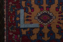 Backside of handmade 2000s Shiraz rug showing knot structure and weave density