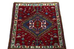 Surface texture of 2000s Shiraz rug with natural Wool and intricate pattern