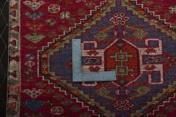 Backside of handmade 2000s Shiraz rug showing knot structure and weave density