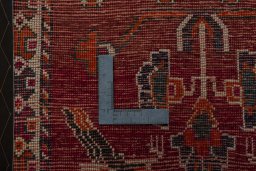 Backside of handmade 2000s Shiraz rug showing knot structure and weave density