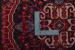 Backside of handmade 2000s Shiraz rug showing knot structure and weave density