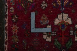 Backside of handmade 2000s Shiraz rug showing knot structure and weave density