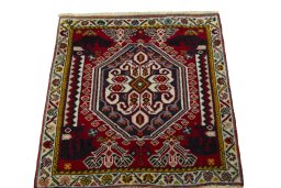 Surface texture of 2000s Shiraz rug with natural Wool and intricate pattern