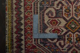 Backside of handmade 2000s Shiraz rug showing knot structure and weave density