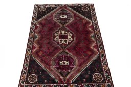 Surface texture of 2000s Shiraz rug with natural Wool and intricate pattern