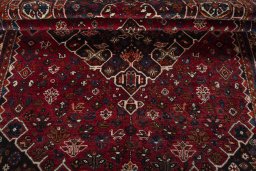 Corner detail of 2000s Shiraz rug showing border pattern and Wool pile