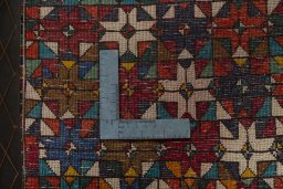 Backside of handmade 2000s Shiraz rug showing knot structure and weave density