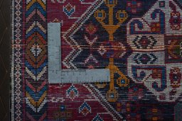 Backside of handmade 2000s Shiraz rug showing knot structure and weave density