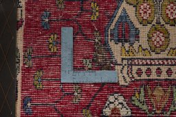 Backside of handmade 2000s Shiraz rug showing knot structure and weave density