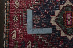 Backside of handmade 2000s Shiraz rug showing knot structure and weave density