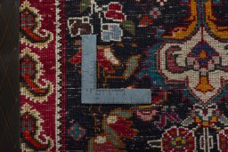 Backside of handmade 2000s Shiraz rug showing knot structure and weave density