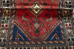 Corner detail of 2000s Shiraz rug showing border pattern and Wool pile