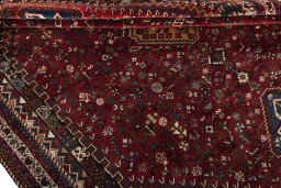 Corner detail of 2000s Shiraz rug showing border pattern and Wool pile