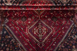 Corner detail of 2000s Shiraz rug showing border pattern and Wool pile