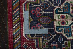 Backside of handmade 2000s Shiraz rug showing knot structure and weave density