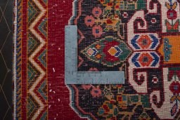 Backside of handmade 2000s Shiraz rug showing knot structure and weave density