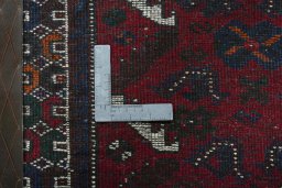 Backside of handmade 2000s Shiraz rug showing knot structure and weave density