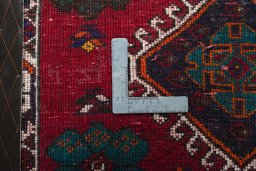 Backside of handmade 2000s Shiraz rug showing knot structure and weave density