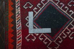 Backside of handmade 2000s Shiraz rug showing knot structure and weave density