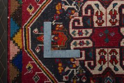 Backside of handmade 2000s Shiraz rug showing knot structure and weave density